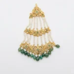 Sha Jewellers Emerald, South Sea Pearl and CZ Jhumar - Traditional Indian bridal side headpiece featuring cascading tiers of lush green emerald stones, lustrous South Sea pearls, and brilliant CZ accents in intricate gold-tone setting