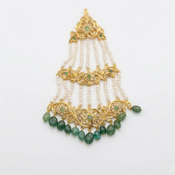 Sha Jewellers Emerald, South Sea Pearl and CZ Jhumar - Traditional Indian bridal side headpiece featuring cascading tiers of lush green emerald stones, lustrous South Sea pearls, and brilliant CZ accents in intricate gold-tone setting