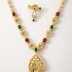 Sha Jewellers Peacock Motif Gemstone Haar and Earring Set featuring rubies, emeralds and white CZ stones in a teardrop pendant with matching drop earrings | Contemporary Temple-Style Jewelry