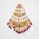 Sha Jewellers Ruby, Pearl and CZ Jhumar - Traditional Indian bridal side headpiece featuring cascading tiers of passionate red ruby stones, lustrous white South Sea pearls, and brilliant CZ accents in gold-tone setting