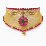 Shah Jewellers 22k Gold Royal Maharani Choker featuring grand emerald-center bloom with intricate scrollwork filigree radiating outward